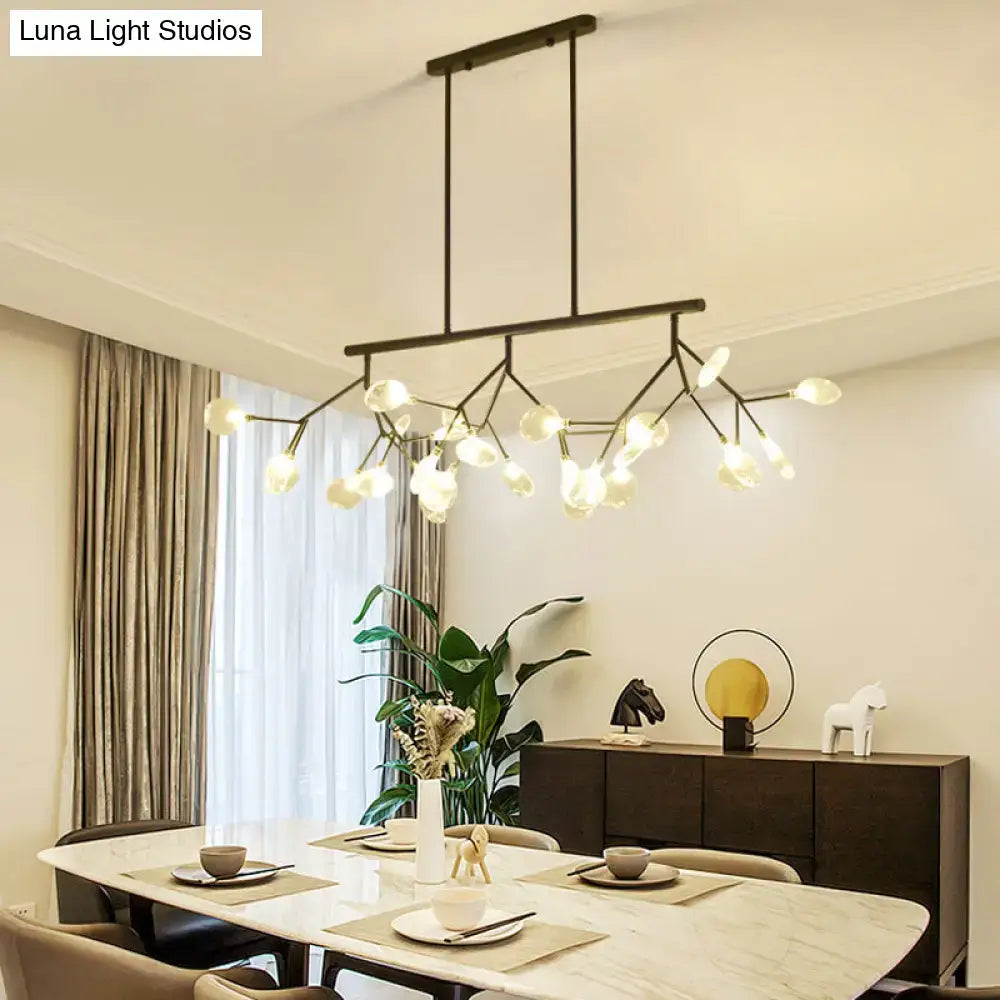 Modern black and gold metal chandelier with branching arms and frosted clear glass globe bulbs for dining room light