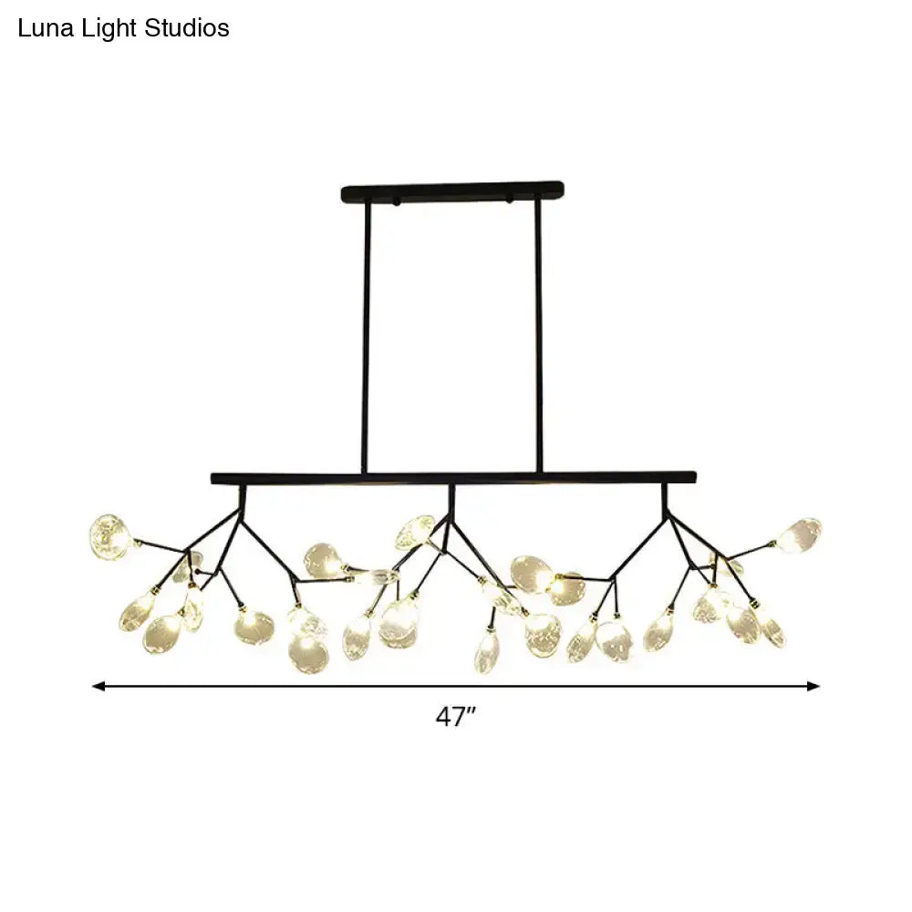 Modern black metal chandelier with branching arms and clear glass teardrop pendant lights for dining room use