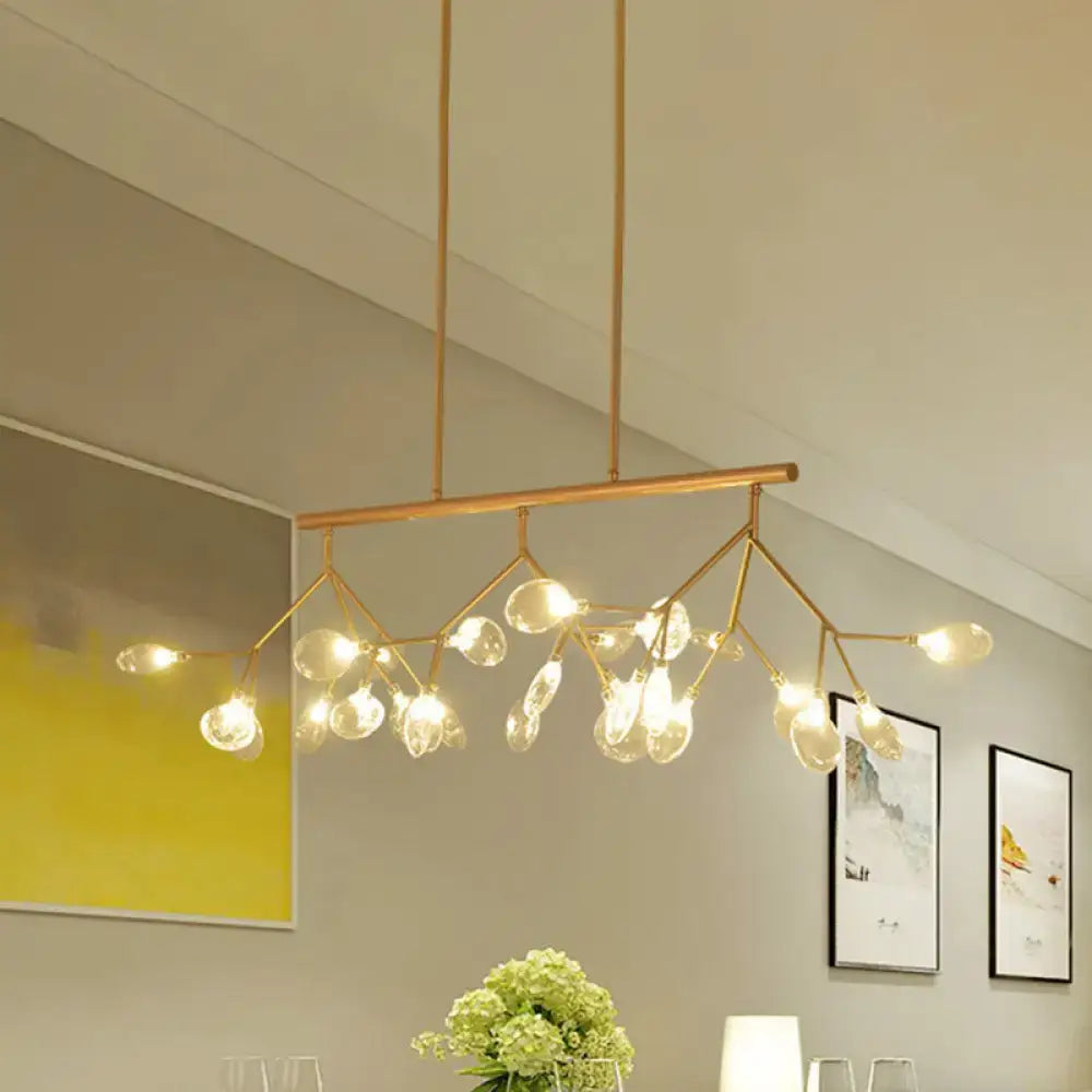 Modern black and gold dining room chandelier with clear glass bubble bulbs and a gold-toned branching metal frame