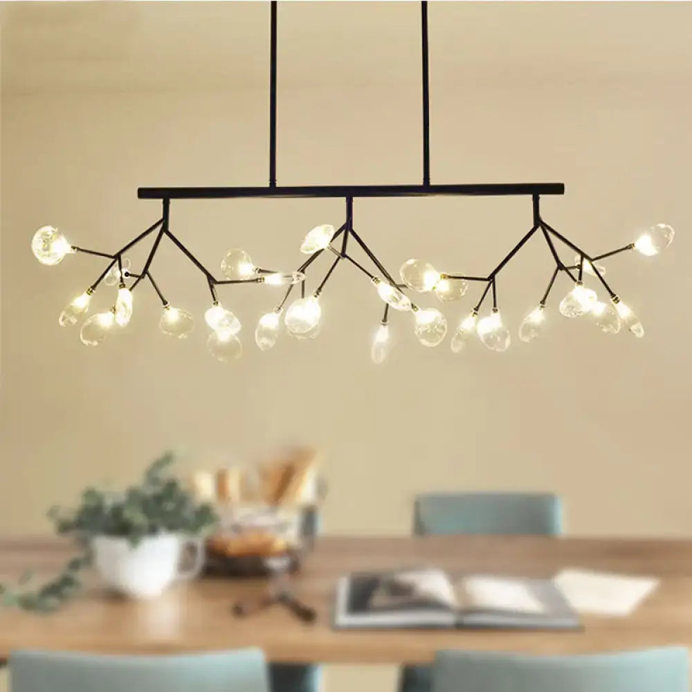 Modern black and gold chandelier with branching arms and clear glass globe bulbs for dining room lighting