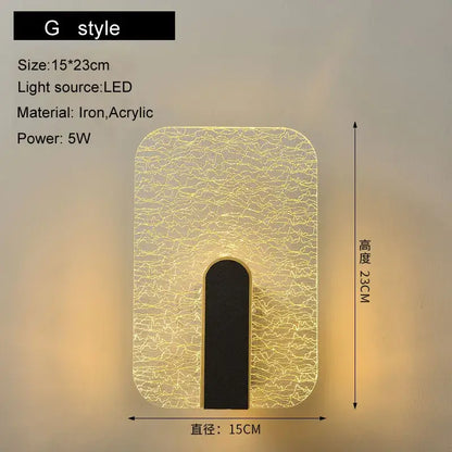 Modern black and gold led wall lamp with crackled acrylic diffuser and iron frame emitting warm yellow light