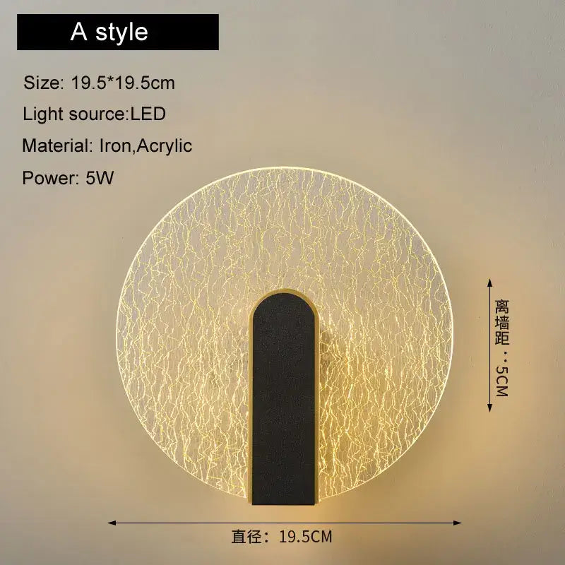 Modern black and gold led wall lamp with crackled acrylic diffuser and black iron base emitting warm yellow light