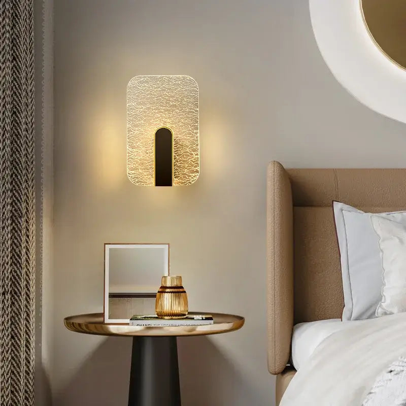 Modern black and gold crackled glass led wall lamp with textured glass face and sleek black vertical accent for bedroom lighting