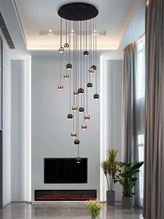A modern black and gold crystal ball pendant light with spherical design and circular ceiling mount for living room decorbites