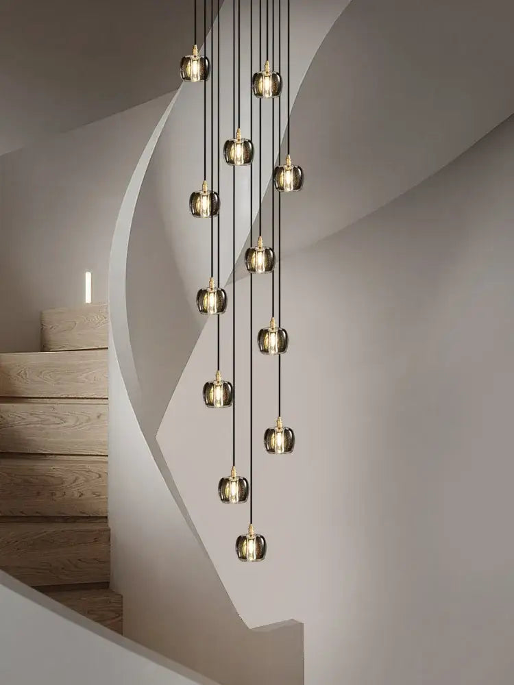 A modern black and gold crystal chandelier led pendant light with glass globe pendants suspended by black cords