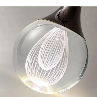 Modern black and gold crystal led ball pendant featuring a clear glass light bulb with etched concentric curved lines decorbites crystal led