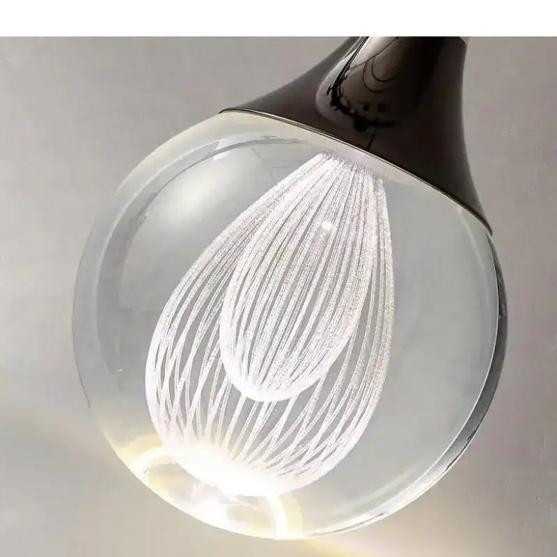 Modern black and gold crystal led ball pendant featuring a clear glass light bulb with etched concentric curved lines decorbites crystal led