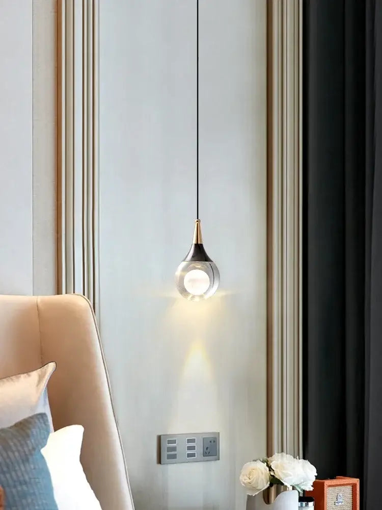 A sleek modern black and gold led ball pendant with a teardrop glass shade and brushed brass accent for dining room decorbites crystal led