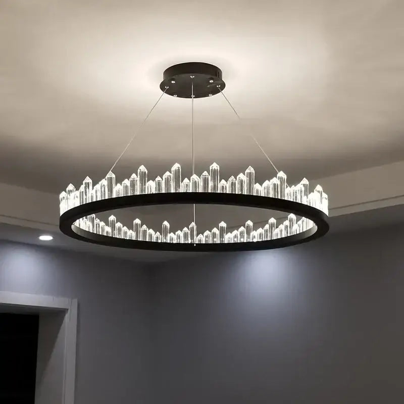 Modern black and gold crystal led pendant lights featuring illuminated crystal led rods in a circular dining room chandelier