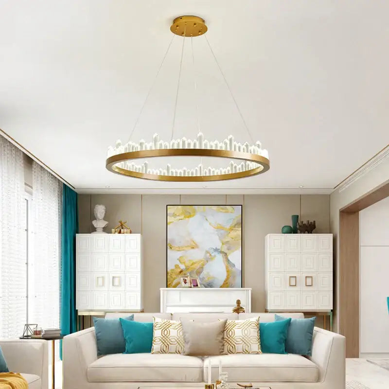 Gold-toned circular decorbites crystal led pendant light with illuminated cityscape design for modern dining rooms