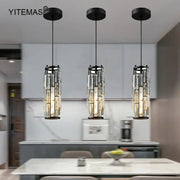 Three black-framed crystal mini pendant lights with cascading rods in a decorbites mini pendant chandelier for kitchen lighting