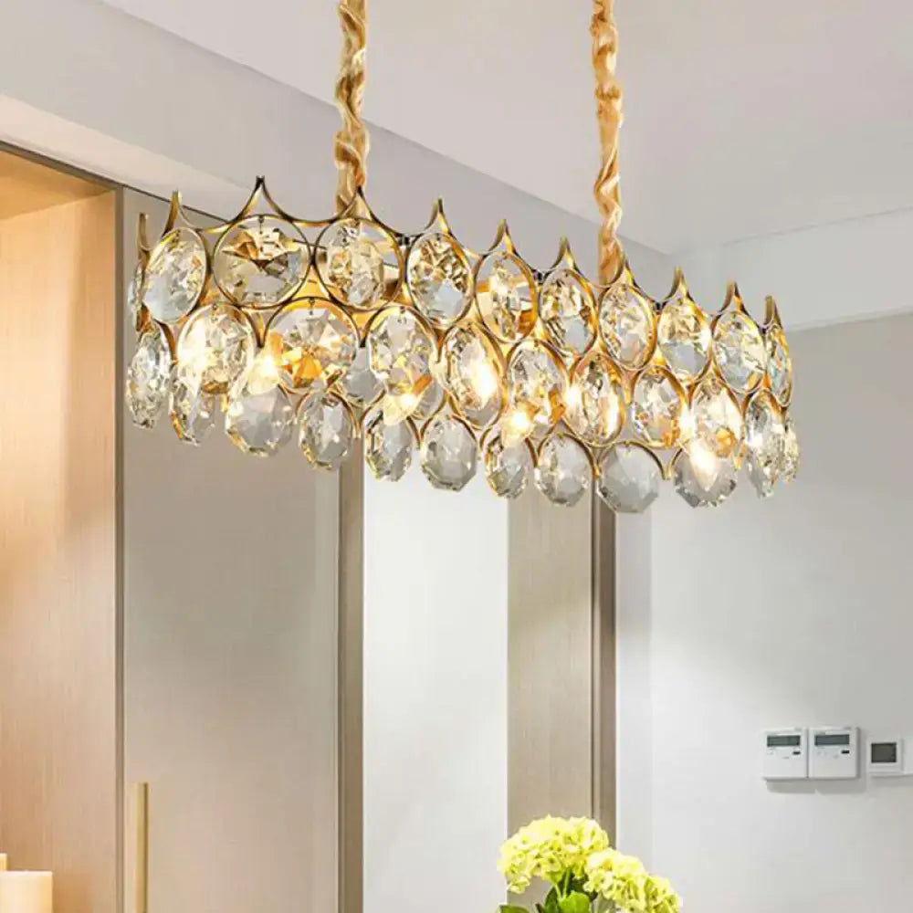Gold-toned modern black pendant lighting fixture with circular crystal prism shade and faceted droplets for dining room