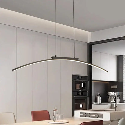 Modern black and gold curved bridge pendant light with sleek minimalist design for dining table illumination