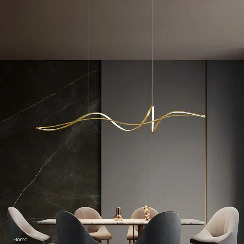 Gold-toned sleek curved pendant light with modern flowing design available in dimmable versions and adjustable color temperature