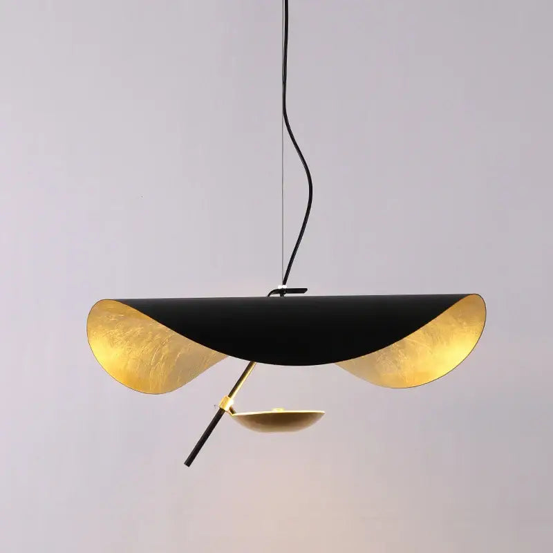 Modern black and gold curved pendant light with sleek design for dining room featuring decorbites lederam manta style