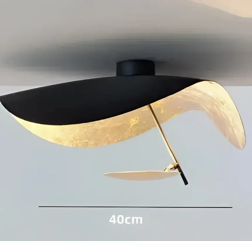 Modern black and gold curved pendant light with sleek design ideal for dining room decorbites lederam manta lamp
