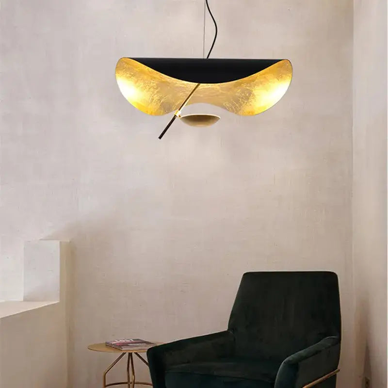 Modern black and gold curved pendant light with sleek design ideal for dining room decorbites lederam manta lamp