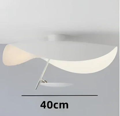 A modern black and gold manta pendant lamp with a curved white translucent shade and slender metallic stem for dining room decorbites lederam manta