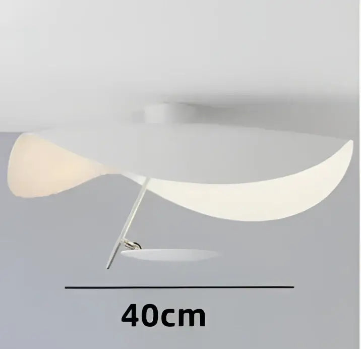 A modern black and gold manta pendant lamp with a curved white translucent shade and slender metallic stem for dining room decorbites lederam manta