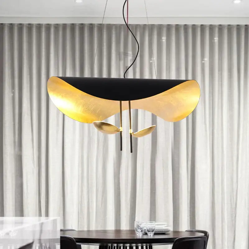 Modern black and gold curved pendant light with sleek metallic finish resembling overlapping petals for dining room decorbites lederam manta