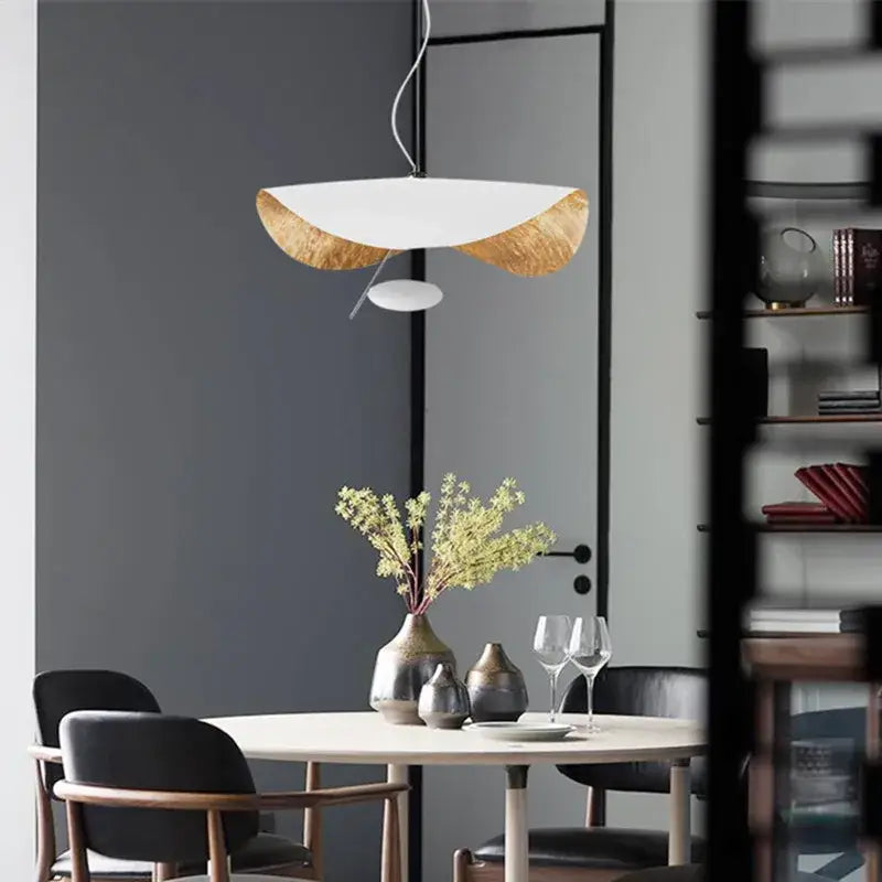 Modern black and gold curved pendant light with white curved shade and gold-leafed edges for dining room decorbites lederam manta