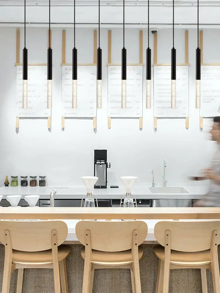 Modern black and gold cylinder pendant lights with frosted glass shades hang as decorbites black cylinder pendant lights