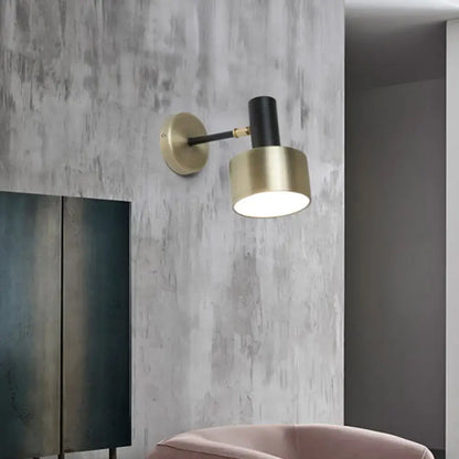 Modern black and gold cylinder sconce with adjustable arm metal wall lighting for living room use