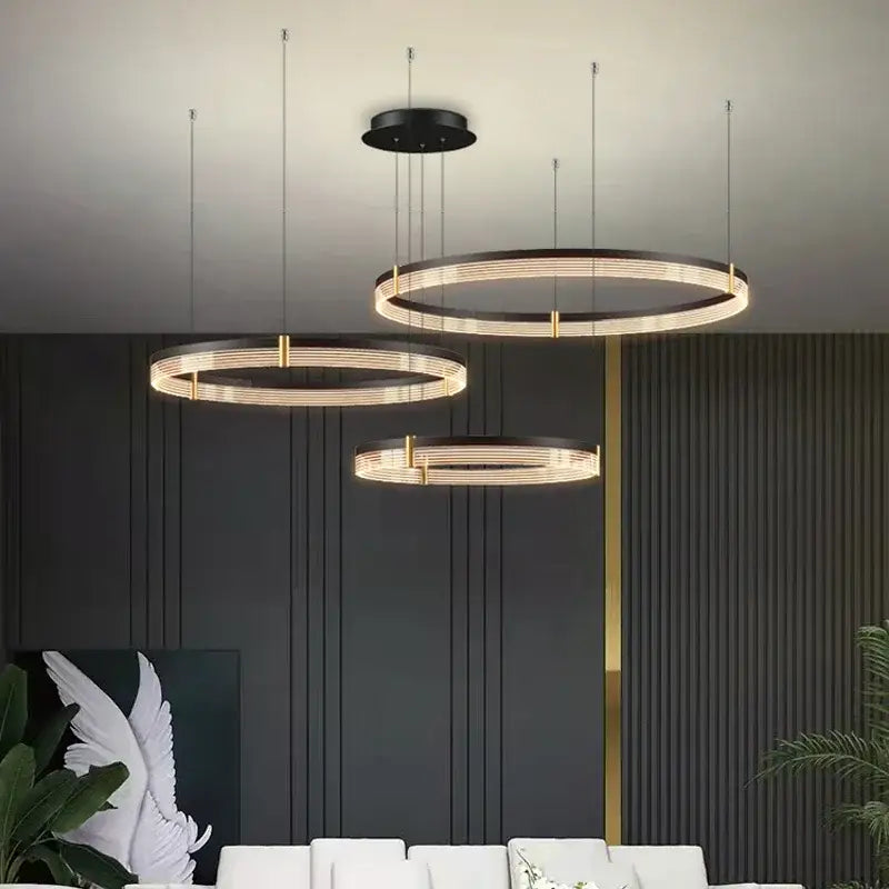 Modern black and gold decorbites circle chandelier with sleek concentric rings and warm led lighting for dining room use