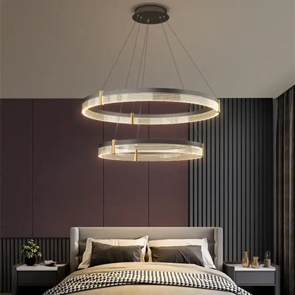 Modern black and gold decorbites circle chandelier featuring sleek metallic double rings and warm LED lighting for dining room