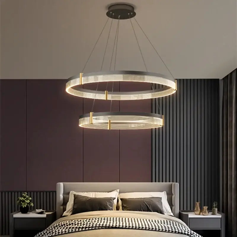 Modern black and gold decorbites circle chandelier featuring sleek metallic double rings and warm LED lighting for dining room