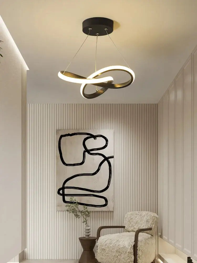 Modern black and gold decorbites contemporary chandelier with sleek infinity loop design for dining room lighting