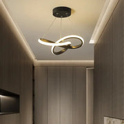 Modern black and gold decorbites contemporary chandelier with infinity loop design and sleek LED illumination for dining room