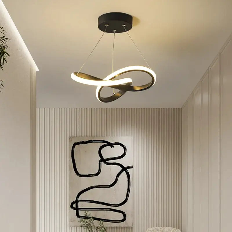 Modern black and gold decorbites contemporary chandelier with sleek infinity loop rings for dining room lighting