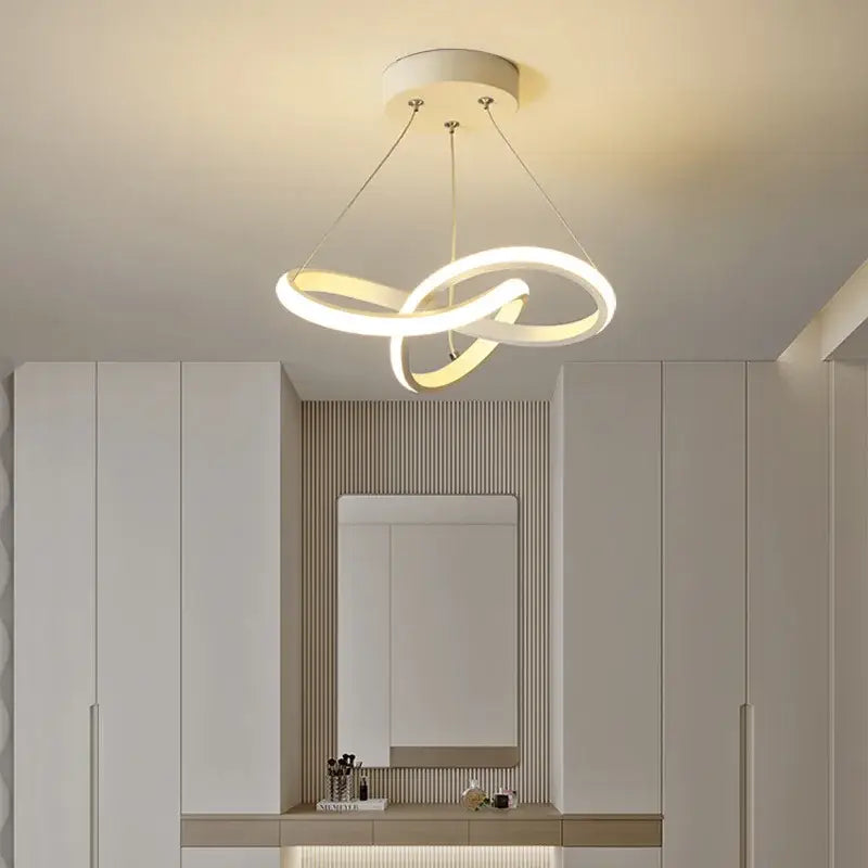 Modern black and gold decorbites contemporary chandelier featuring a white led intertwined circular rings design for dining rooms