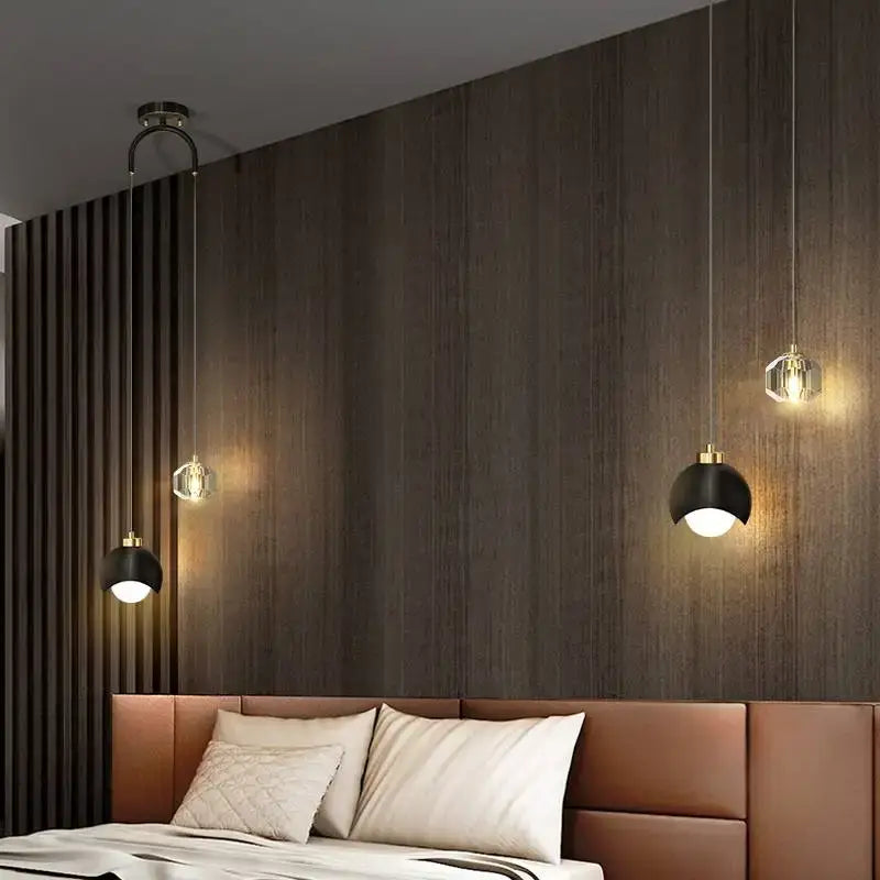 Modern black and gold decorbites crystal round chandelier with pendant lights and clear glass shades over leather headboard