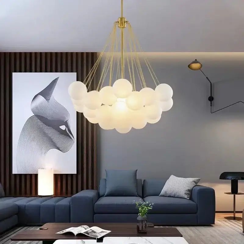 Modern black and gold decorbites glass chandelier with gold-toned cloud pendant and frosted glass orbs for dining room light