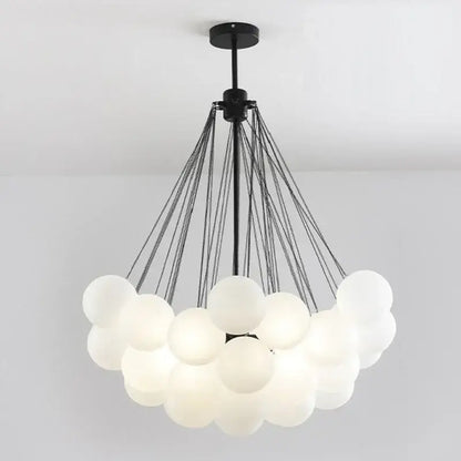 Modern black and gold decorbites glass chandelier with frosted white glass spheres for dining room lighting