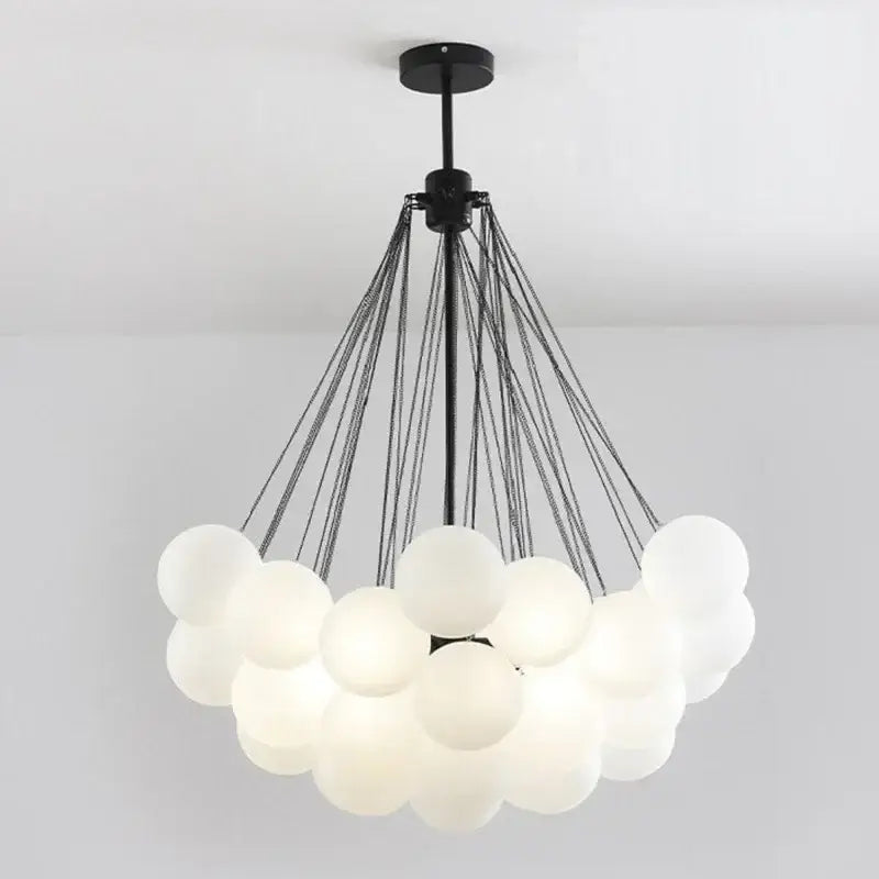 Modern black and gold decorbites glass chandelier with frosted white glass spheres for dining room lighting