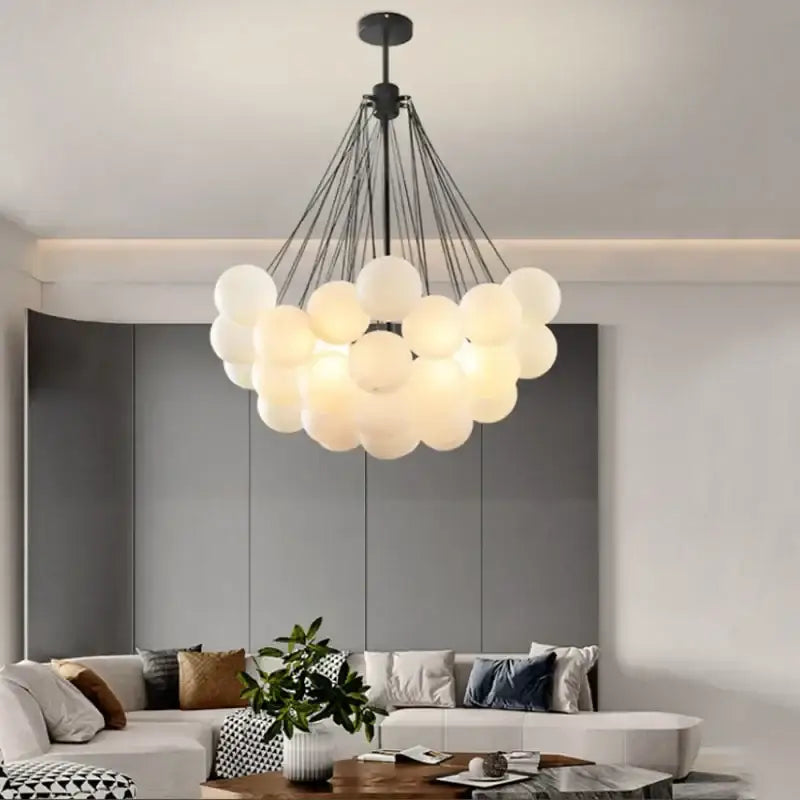 Modern black and gold decorbites glass chandelier with frosted glass spheres on metal arms for dining room lighting