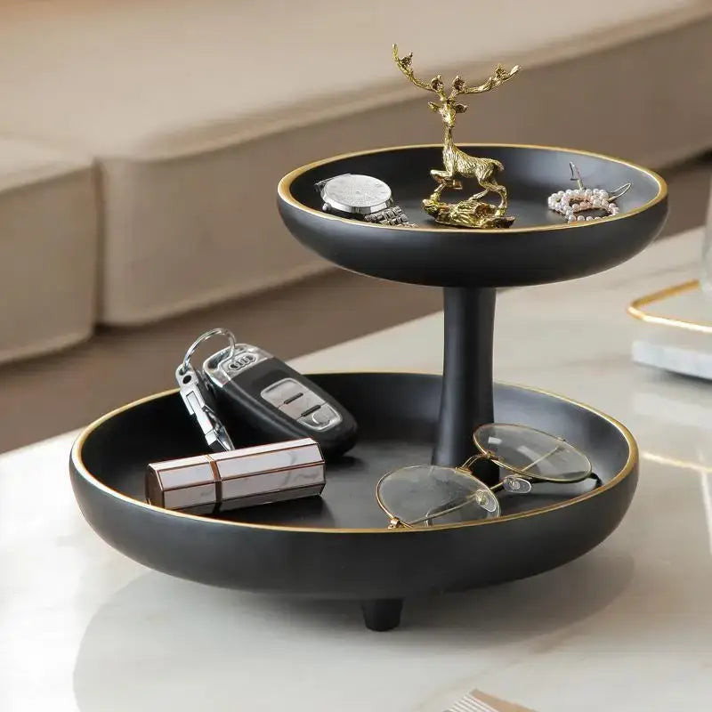 Modern black and gold two-tiered coffee table tray with gold rim and golden deer figurine on the top tier