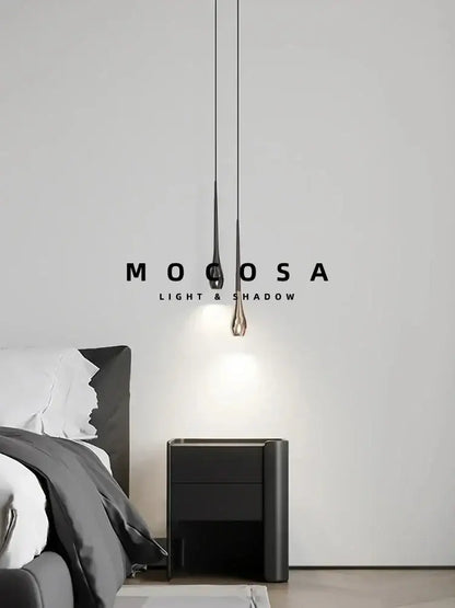 Modern black and gold droplet pendant light with sleek teardrop design metallic finish and remote control for dining room