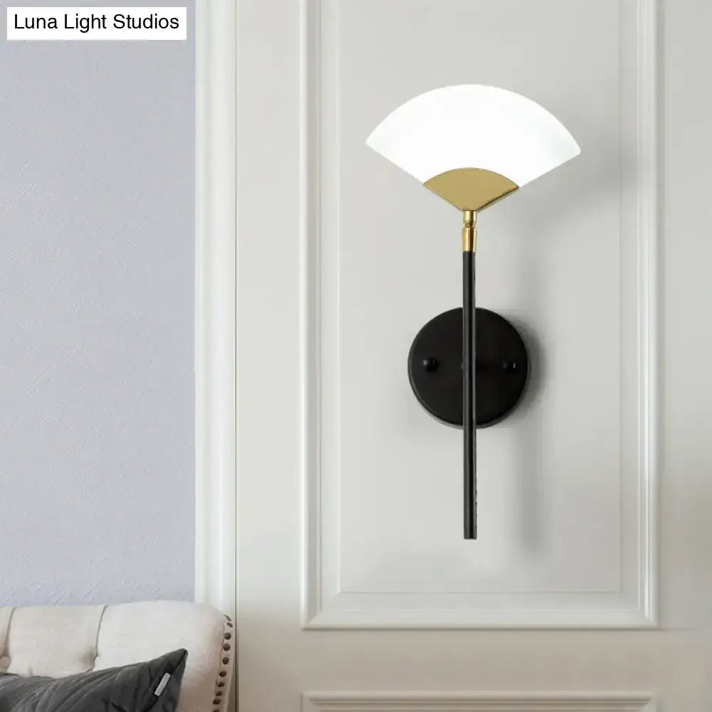 Modern black and gold fan wall mount light with white glass shade and metal accent for bedroom lighting