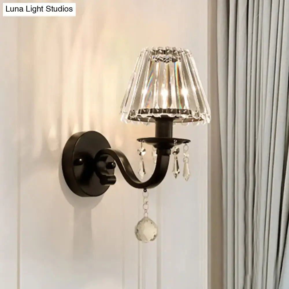 Modern black wrought iron wall sconce with faceted crystal shade and black gold finish for living room fixture height