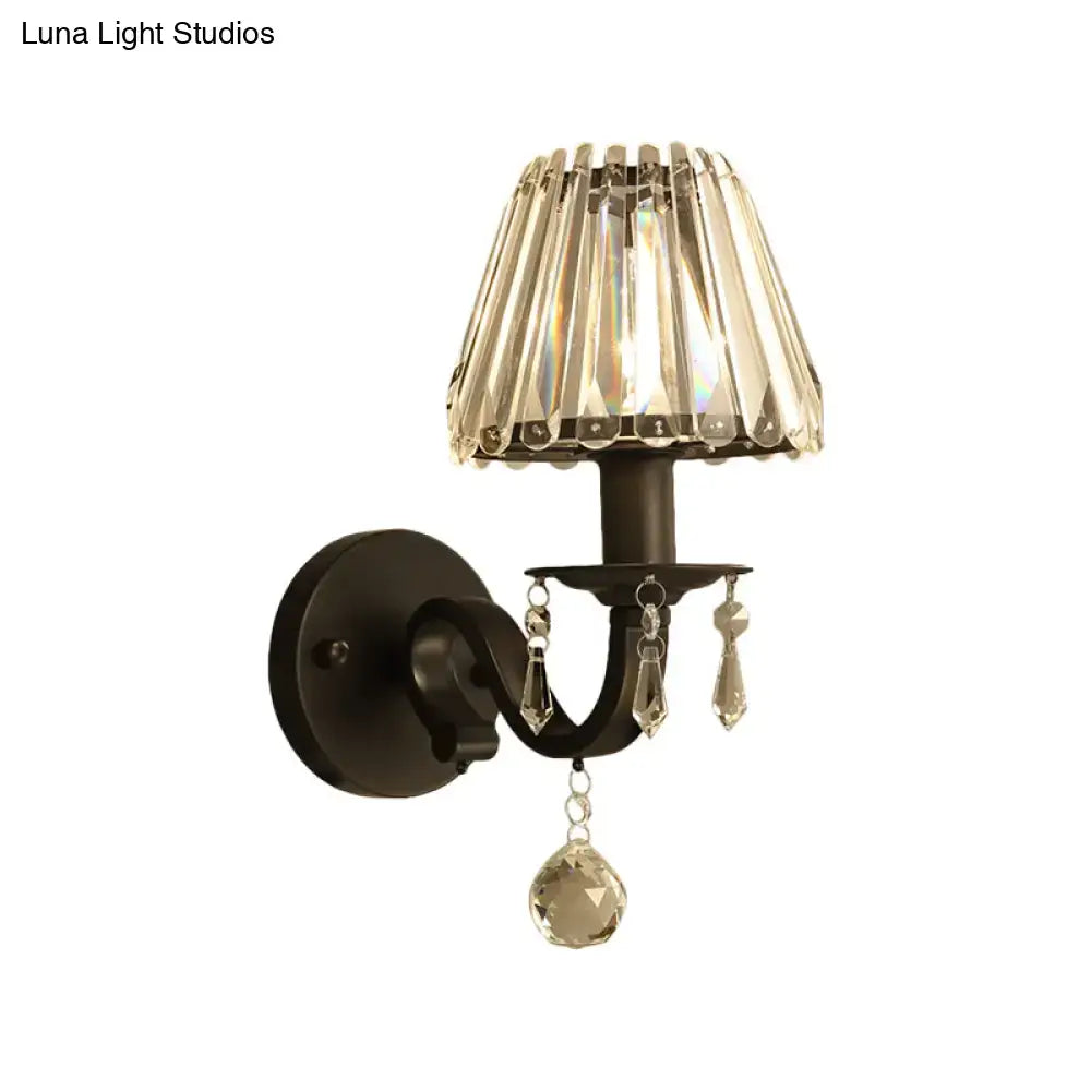 Elegant black wrought iron wall sconce with cascading crystal shade and dangling crystals in modern black gold finish