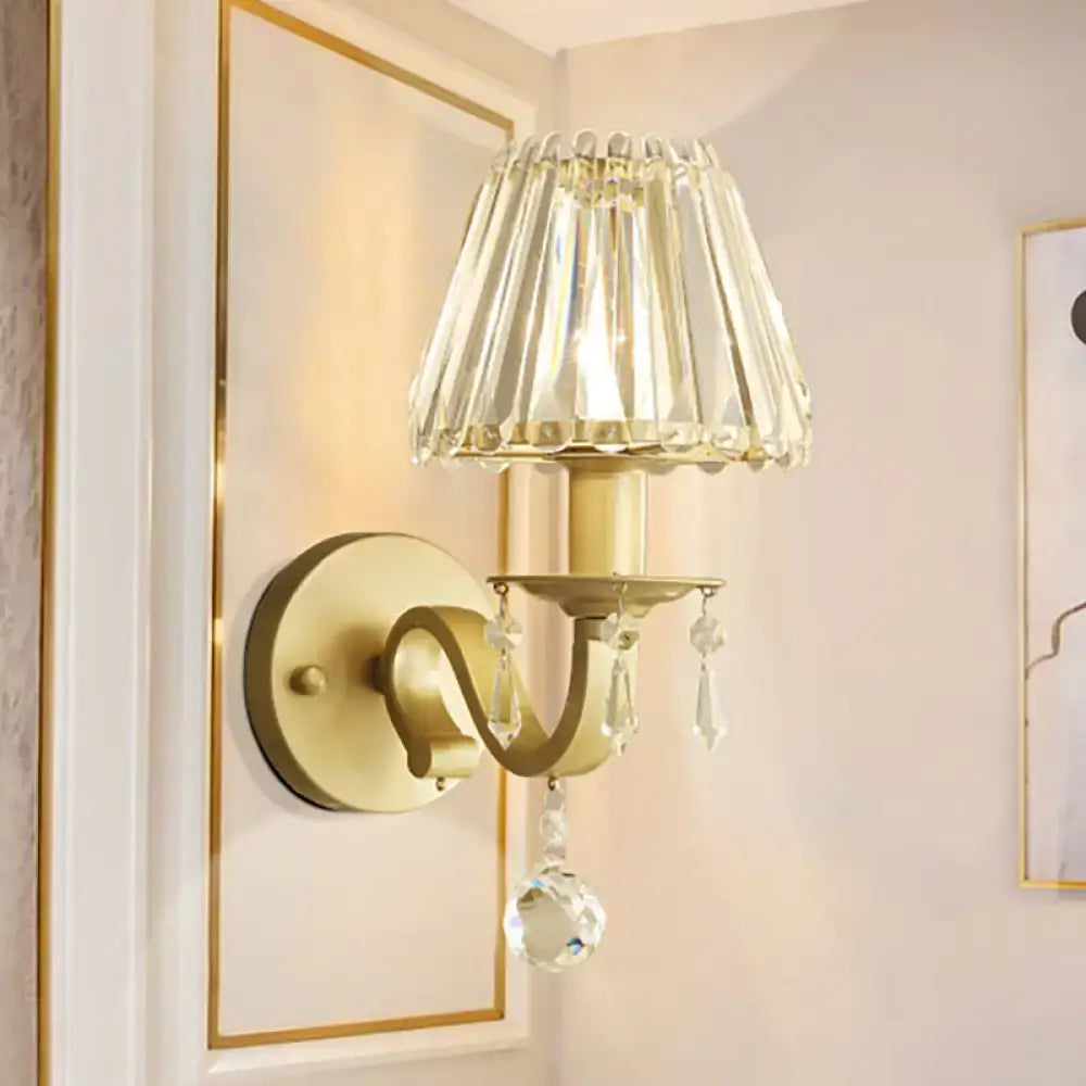 Modern black gold finish wall sconce with gold finish faceted crystal shade and dangling crystals for living room