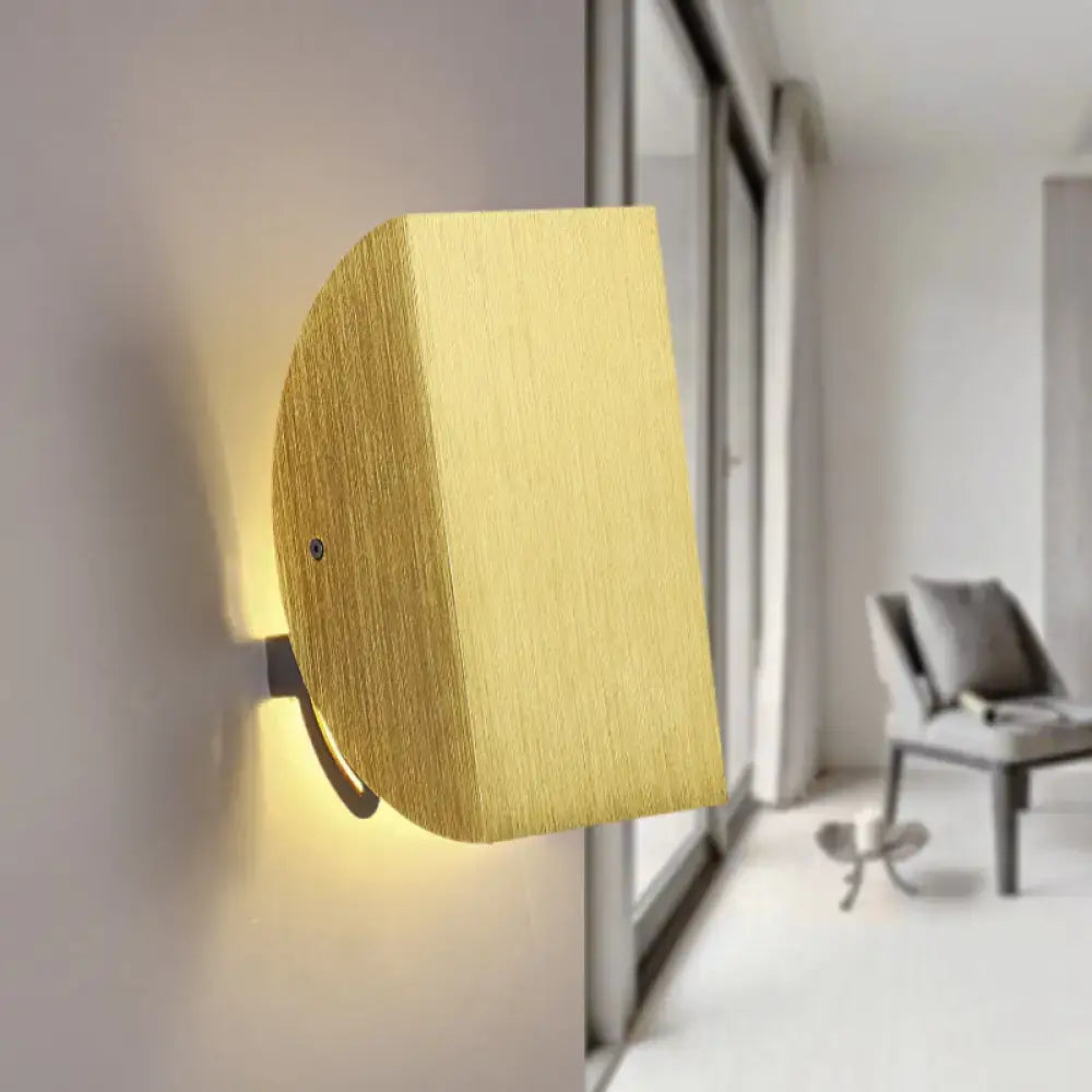 Gold-finished brushed metal folded wall light sconce with sleek rectangular design providing warm ambient lighting