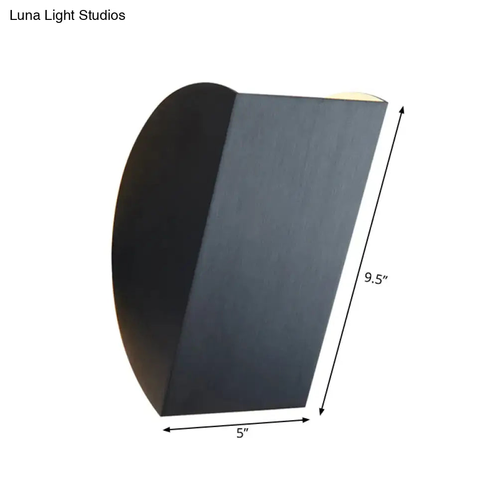 Modern black matte folded wall light sconce with gold accents and curved design for bedroom decor lighting