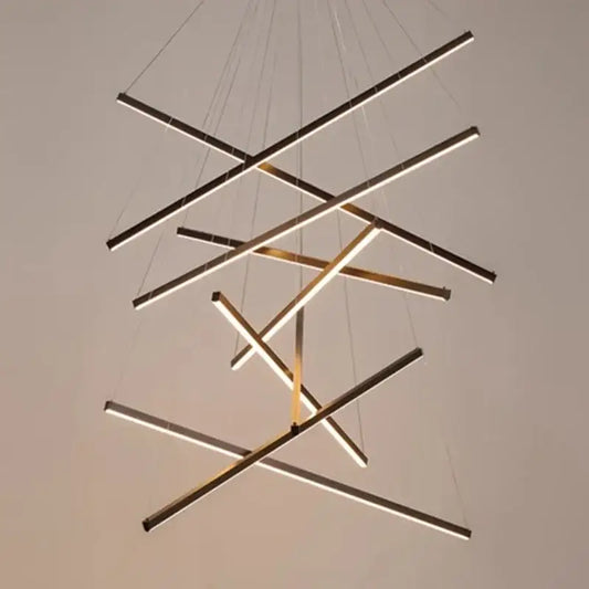 Modern black and gold geometric led pendant light with intersecting linear bars and warm light for dining room use