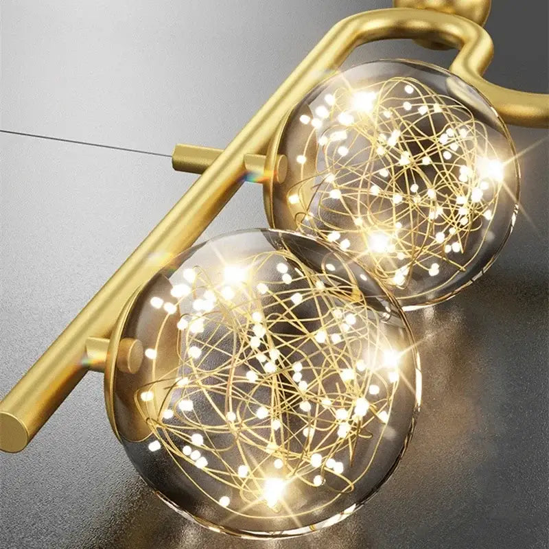 Modern black and gold chandelier pendant with two glass ball led orbs filled with golden wire for dining room decorbites glass ball