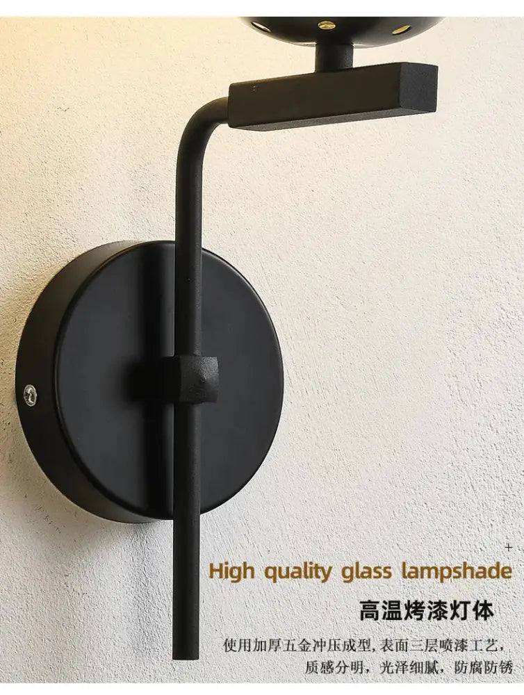 Modern black matte wall lamp with curved arm and high-quality glass ball led shade by decorbites for bedroom decor